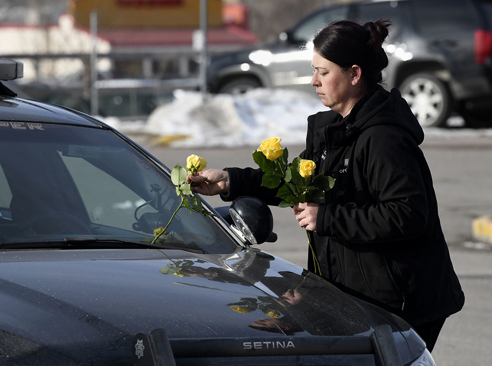 Tara Chevalier places a rose